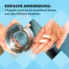 Hands holding a glass of water and two capsules, with text overlay. Produktbild-Vorschau