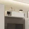 A white wall-mounted cabinet with decorative items on top. Produktbild-Vorschau