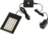 A black LED lamp with a power adapter and control box, arranged on a white background. Anteprima dell’immagine prodotto