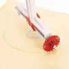 A close-up view of a pastry wheel cutter making a decorative edge on a sheet of dough. Podgląd zdjęcia produktu