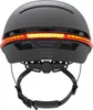 The back view of a black bicycle helmet with a red LED light strip. Náhled obrázku produktu