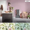A kitchen island with a chalkboard menu and decorative crates in a room with pink walls. Produktbild-Vorschau