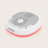 A white and gray baby sleep aid device with a red light ring around the base, shown from a slightly elevated angle against a light gray background. Náhľad obrázku produktu