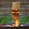 Two chickens are being roasted over an open fire on a wooden board with a metal rack. Produktbild-Vorschau