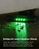 A vacuum cleaner head with green LED lights illuminating dust on a wooden floor. Produktbild-Vorschau