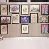 A collection of framed children's artwork displayed on a tiled wall. Anteprima dell’immagine prodotto