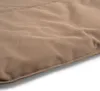 A close-up view of beige fabric with visible stitching along the edge. Voir les images du produit