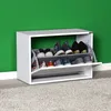 A white shoe cabinet with shoes on display against a green wall. Podgląd zdjęcia produktu