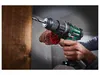 A person is using a cordless drill to drill into a wooden surface. Sawdust is flying around the drill bit. Podgląd zdjęcia produktu