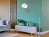 A modern living room with a sofa, a white cabinet, a floor lamp, and a plant. Produktbild-Vorschau