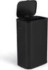 A black rectangular trash can with its lid open, shown from a slightly angled side view against a white background. Produktbild-Vorschau