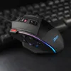 A close-up shot of a gaming mouse on a dark surface, with a blurred keyboard in the background. Podgląd zdjęcia produktu