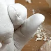 A close-up of a hand covered in white casting material, showing finger details. Náhled obrázku produktu