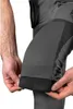 A close-up shot of a person's hands adjusting the cuff of dark gray work pants. Náhľad obrázku produktu