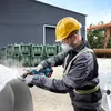 A person wearing safety gear is using a cordless angle grinder. Náhľad obrázku produktu