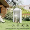 A white greenhouse with plants inside, set up in a backyard with a wooden house and a lounge chair. Produktbild-Vorschau