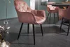 A dining room scene with a pink velvet armchair in the foreground and other chairs and a table in the background. Produktbild-Vorschau
