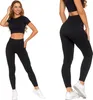A woman modeling black leggings and a crop top. Produktbild-Vorschau
