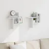Two white wall shelves mounted on a white wall above a sofa. Podgląd zdjęcia produktu