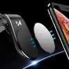 A magnetic phone holder is shown attached to a car's air vent, with a metal plate about to attach to a smartphone. Voir les images du produit