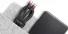 A black and red USB-C cable is neatly bundled and placed in a light gray felt pouch next to a black smartphone. Podgląd zdjęcia produktu