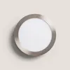 A round LED ceiling light with a silver metal frame and a white diffuser, mounted on a light beige wall. Produktbild-Vorschau