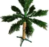 A close-up view of the lower section of an artificial Christmas tree with a faux snow-covered trunk and a green stand. Podgląd zdjęcia produktu