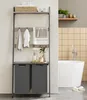 A modern bathroom with a ladder shelf unit containing towels and storage bins next to a bathtub. Produktbild-Vorschau