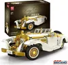 A white and gold vintage car model is displayed in front of its packaging. Voir les images du produit