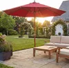 A garden patio with outdoor furniture and a large red umbrella. Produktbild-Vorschau