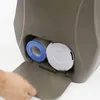 A hand is opening a compartment on a gray spa unit, revealing two filters inside. Podgląd zdjęcia produktu