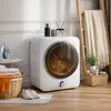 A laundry room or bathroom setting with a dryer, laundry basket, iron, and decor. Produktbild-Vorschau