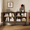 A sideboard with open doors displaying books and decorative items, set in a room. Anteprima dell’immagine prodotto