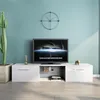 A modern living room setup featuring a white TV stand with a television and decorative items. Produktbild-Vorschau