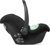 A side view of a black baby car seat with green accents. Anteprima dell’immagine prodotto