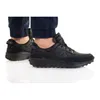 A person wearing black Nike Waffle Debut sneakers. Náhled obrázku produktu