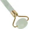 A close-up shot of a jade facial roller with a gold-colored metal frame, isolated on a white background. Náhled obrázku produktu