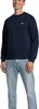 A man wearing a blue sweatshirt and light blue jeans, standing against a white background. Anteprima dell’immagine prodotto