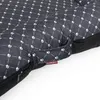 Close-up of a dog bed with a paw print pattern. Produktbild-Vorschau