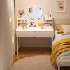 A bedroom scene featuring a vanity table with makeup and a bed with yellow bedding. Podgląd zdjęcia produktu