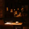 A dimly lit cafe or dining area with a table set for one. Produktbild-Vorschau