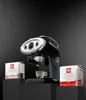 An Illy espresso machine with coffee capsules displayed on black pedestals against a black background. Podgląd zdjęcia produktu