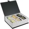 A gift box containing six scented candles, with a decorative pattern on the inside of the box and on some of the candles. Produktbild-Vorschau