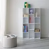 A white bookshelf filled with books and decorative items stands against a white wall. Anteprima dell’immagine prodotto