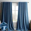 Two blue velvet curtains hanging in front of a window. Produktbild-Vorschau