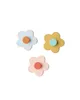 Three flower-shaped wall hooks in different pastel colors with contrasting colored centers, arranged in a triangular formation on a white background. Produktbild-Vorschau