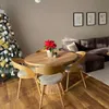 A dining table with chairs in a living room decorated for Christmas. Náhled obrázku produktu