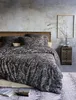 A bedroom scene with a bed dressed in paisley patterned bedding. Produktbild-Vorschau