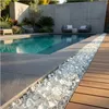 Transparente Glaskristalle als Dekoration in einer Fuge am Swimmingpool im Außenbereich Produktbild-Vorschau