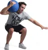 A man is performing a squat exercise with a medicine ball on his shoulder. Produktbild-Vorschau